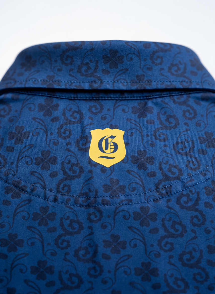 Men's 1502 Polo from Grand Links Collection, in classic design with a collar and short sleeves, displayed on a hanger.