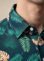 Men's Tropical Jungle Polo by Caribbean Collection featuring a vibrant green tropical jungle print on a classic polo shirt.